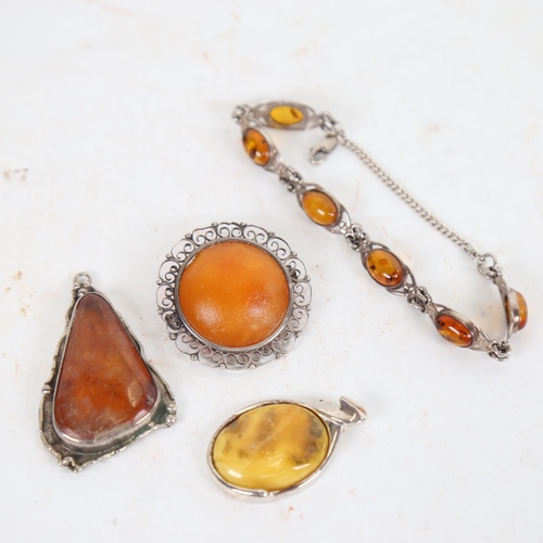 910 - Various Baltic amber silver-mounted pendants, and an amber panel bracelet