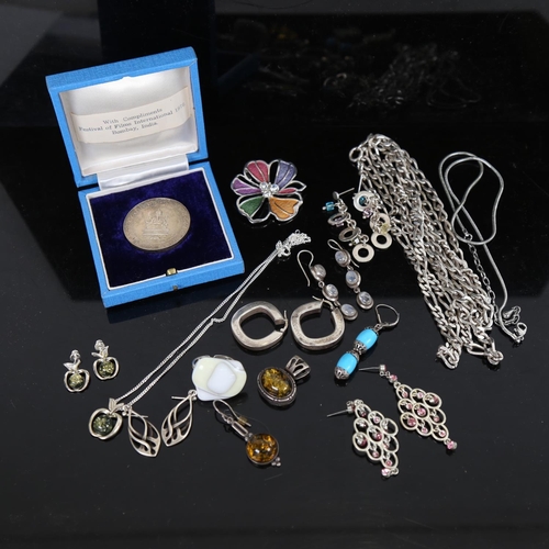 915 - A collection of silver and unmarked metal costume jewellery, including amber and moonstone set piece... 