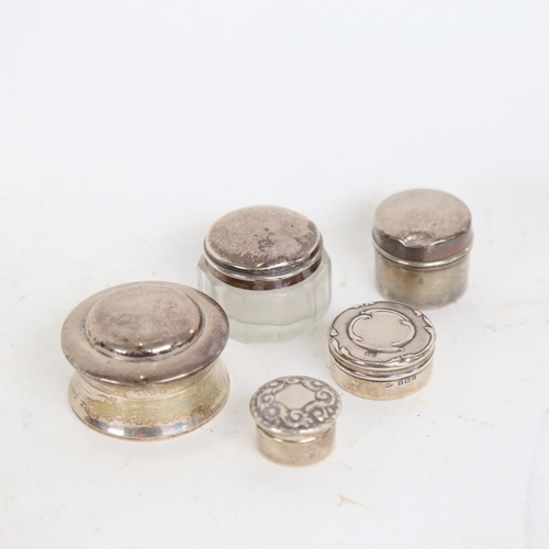 936 - 4 small silver pill pots, and a glass and silver-lidded pot, 2.1 weighable ounces (5)