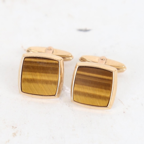 955 - A pair of 9ct gold cufflinks with tigers eye panels