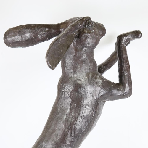 104 - A pair of large patinated bronze boxing hare garden sculptures, largest height 88cm