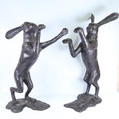 104 - A pair of large patinated bronze boxing hare garden sculptures, largest height 88cm