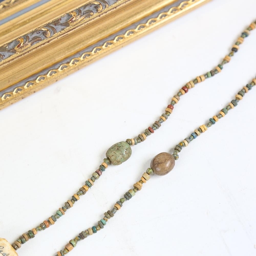 114 - An Ancient Egyptian faience bead triple-strand necklace, framed with old collection label, and 1 oth... 