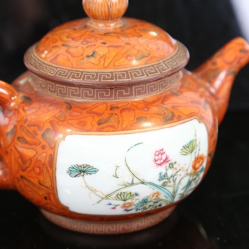 118 - A Chinese red glaze porcelain teapot, finely enamel painted floral panels, seal mark, height 11cm