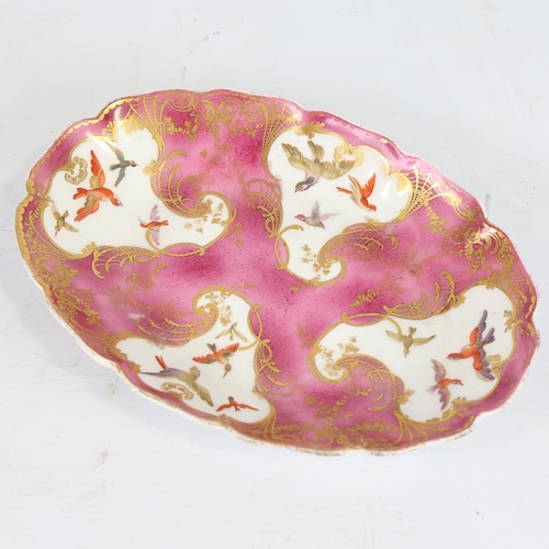 128 - An oval porcelain dish, 18th or 19th century, hand painted and gilded bird decorated panels, with go... 