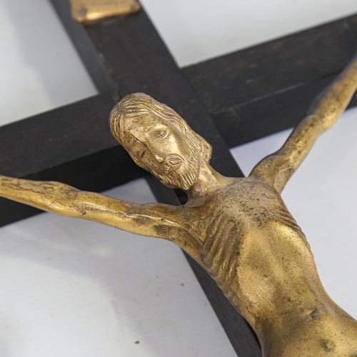 141 - A gilt-bronze and ebony crucifix, length 63cm, and a mother-of-pearl and rosewood inlaid cross, leng... 