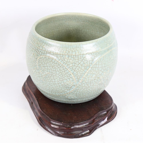 145 - A Chinese celadon crackle glaze jardiniere, height 15cm, overall diameter 19cm, on hardwood stand