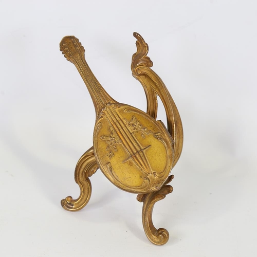 160 - A 19th century French gilt-brass cased trinket box, in the shape of a mandolin on stand, hinged cove... 