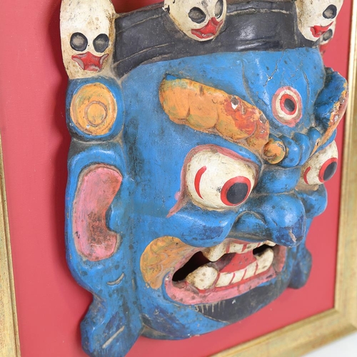 187 - An Oriental relief carved and painted wood ceremonial mask, probably early 20th century, in modern g... 