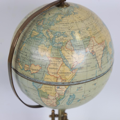 192 - A tinplate and brass desk globe, height 36cm, diameter approx 16cm