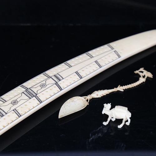 205 - A marine ivory Cribbage marker, early 20th century, length 33cm, together with an ornate carved bone... 