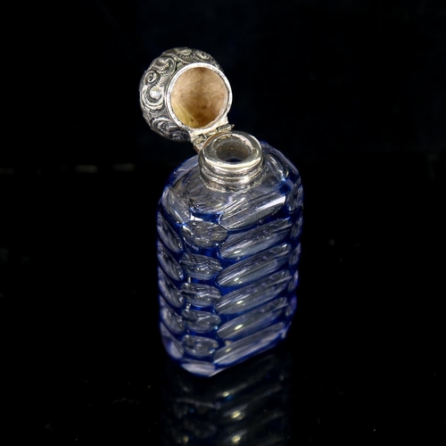 206 - A small blue overlay cut-glass perfume bottle, with unmarked white metal top, height 7cm