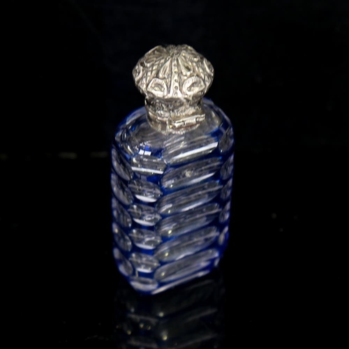 206 - A small blue overlay cut-glass perfume bottle, with unmarked white metal top, height 7cm