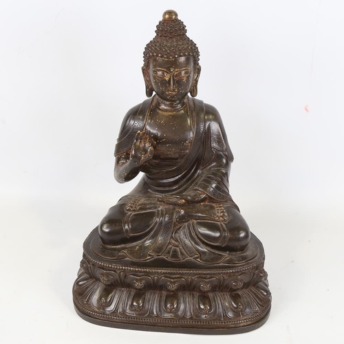 212 - A Chinese patinated bronze seated Buddha, height 36cm