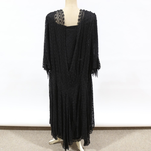 228 - A heavy lace embroidered black evening dress, circa 1890 - 1910, fully lined