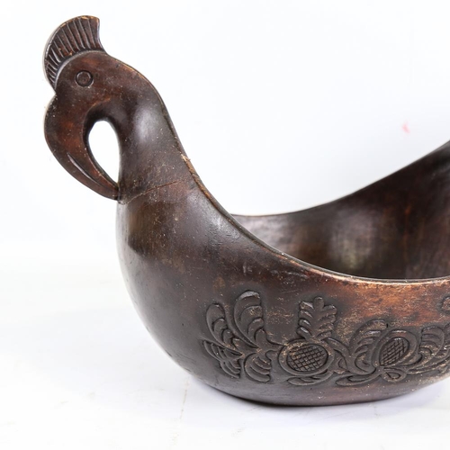 254 - A large Russian carved and stained wood bowl, in the style of a Kovsh, length 48cm