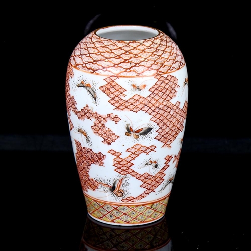 257 - A Japanese porcelain vase, with painted butterflies and geometric design, signed under base, height ... 