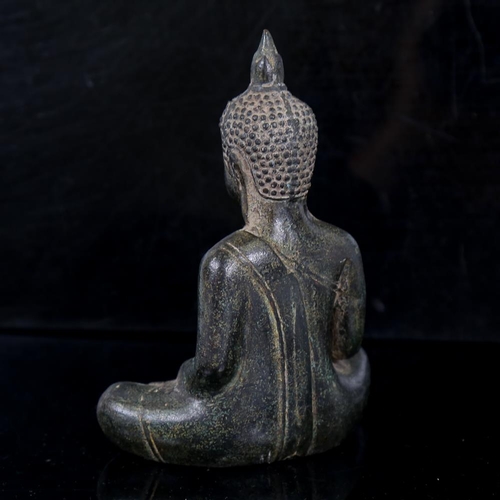 259 - An Oriental patinated bronze seated Buddha, thought to be 15th/16th century, height 14.5cm