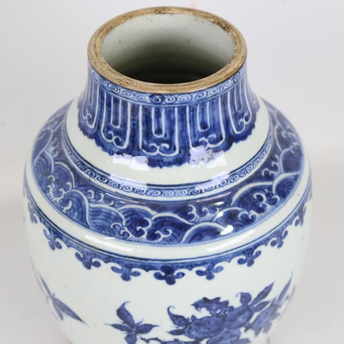 261 - A Chinese blue and white porcelain vase, hand painted prunus decoration, height 28cm, base drilled