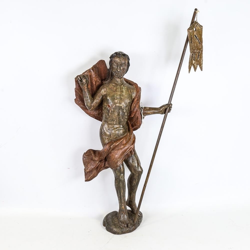 273 - A carved and painted wood religious figure carrying a pennant, probably 18th century, height 57cm