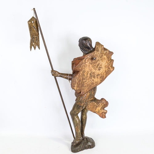 273 - A carved and painted wood religious figure carrying a pennant, probably 18th century, height 57cm