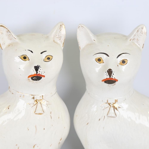 294 - A rare pair of 19th century Staffordshire Pottery seated cats, height 34cm