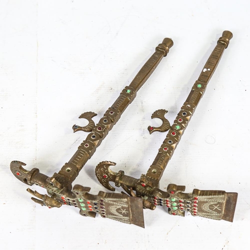 306 - A pair of South American brass ceremonial axes, with inset coloured glass bosses, length 30cm