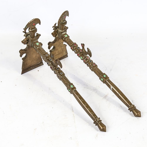 306 - A pair of South American brass ceremonial axes, with inset coloured glass bosses, length 30cm