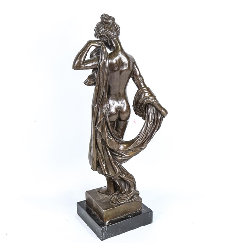 307 - A reproduction patinated bronze sculpture, female nude, unsigned, on black marble base, height 43cm