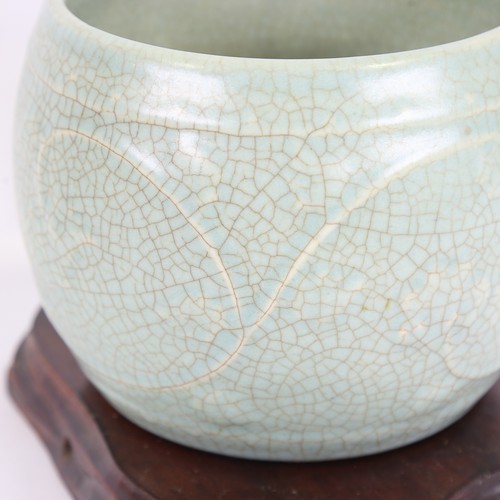 145 - A Chinese celadon crackle glaze jardiniere, height 15cm, overall diameter 19cm, on hardwood stand