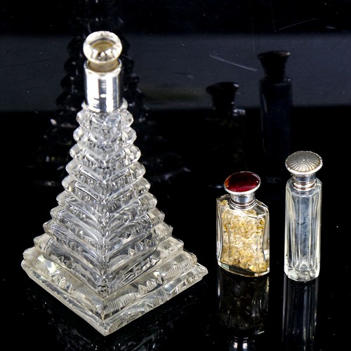 156 - A step-cut glass perfume bottle with silver collar, height 15cm, and a small silver and enamel-toppe... 