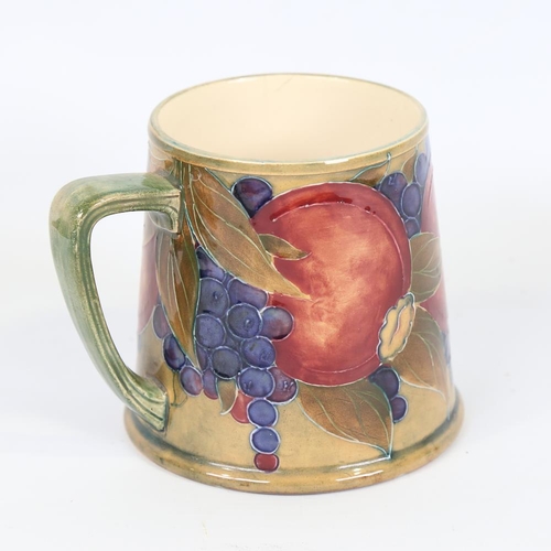 354 - MOORCROFT - Pomegranate and Grape pattern pint mug, made for Liberty & Co, registered no. 452777, he... 