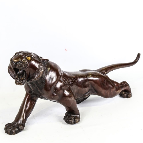 250 - An Meiji period, Japanese, patinated bronze tiger, with makers stamp to underside, length 65cm