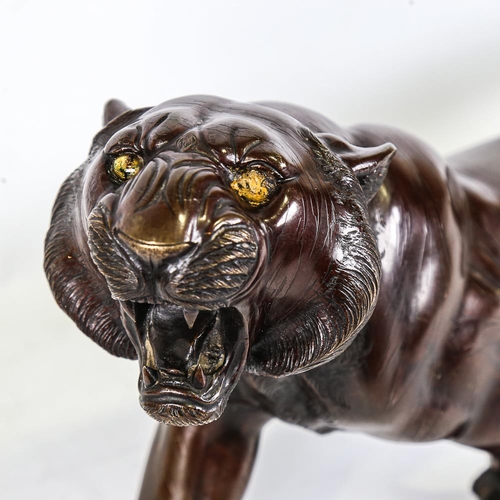 250 - An Meiji period, Japanese, patinated bronze tiger, with makers stamp to underside, length 65cm