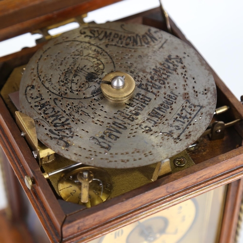 102 - A 19th century German walnut-cased symphonion table clock, carved and brass-mounted case, the top op... 