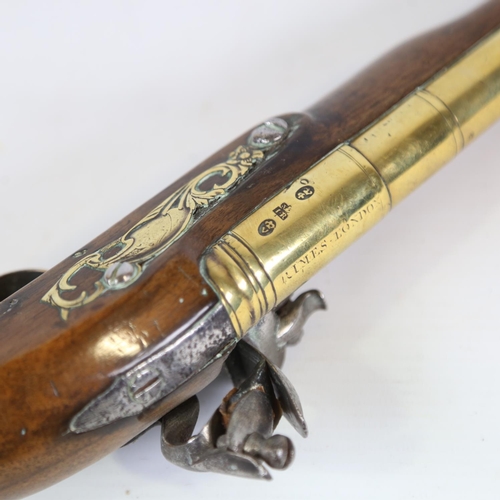 78 - A George II brass-barrelled flintlock coaching pistol, barrel stamped Rimes London, engraved brass t... 