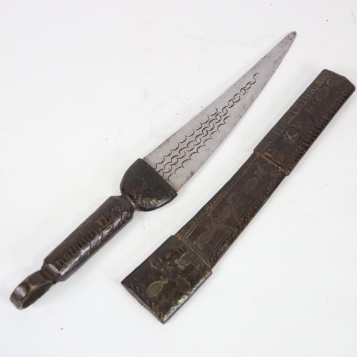 81 - An African hunting knife, with embossed leather scabbard and handle, overall length 44cm