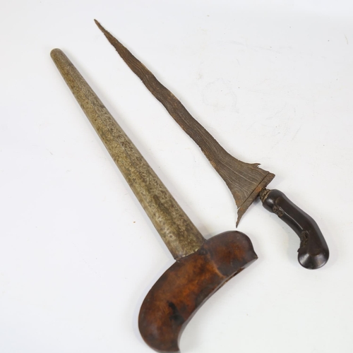 82 - A Malayan Kris knife, with carved horn handle and white metal scabbard, overall length 52cm