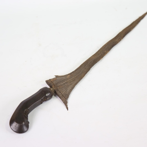 82 - A Malayan Kris knife, with carved horn handle and white metal scabbard, overall length 52cm