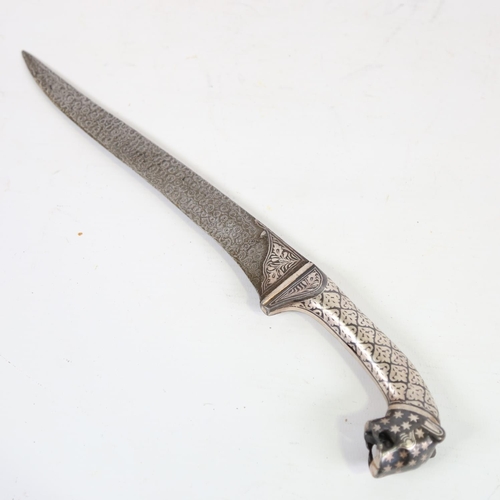 83 - An ornate Middle Eastern white metal inlaid knife, with leopard-head handle, length 30cm