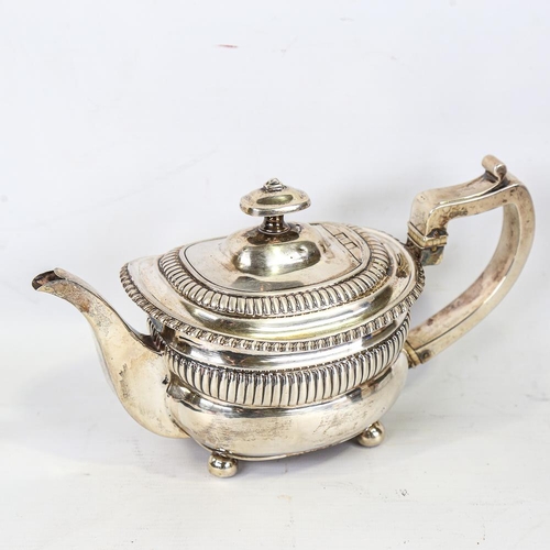 586 - A Georgian silver teapot, oval bulbous form with fluted decoration and gadrooned rim, with ivory ins... 