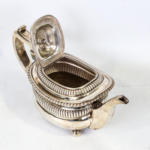 586 - A Georgian silver teapot, oval bulbous form with fluted decoration and gadrooned rim, with ivory ins... 