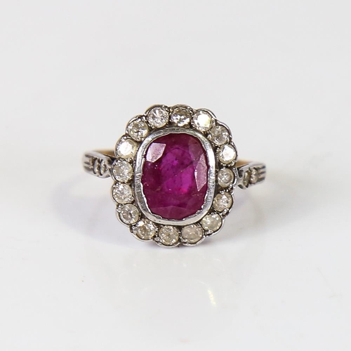 593 - A Vintage ruby and diamond cluster ring, unmarked gold and silver settings, with oval mixed-cut ruby... 