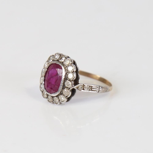 593 - A Vintage ruby and diamond cluster ring, unmarked gold and silver settings, with oval mixed-cut ruby... 