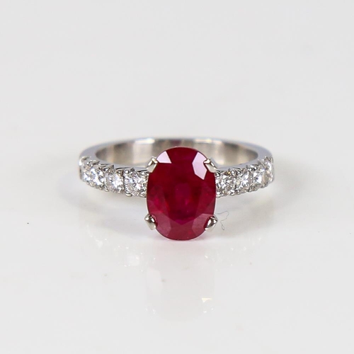 597 - A Burmese ruby and diamond dress ring, unmarked platinum settings with a 2.13ct oval mixed-cut ruby ... 