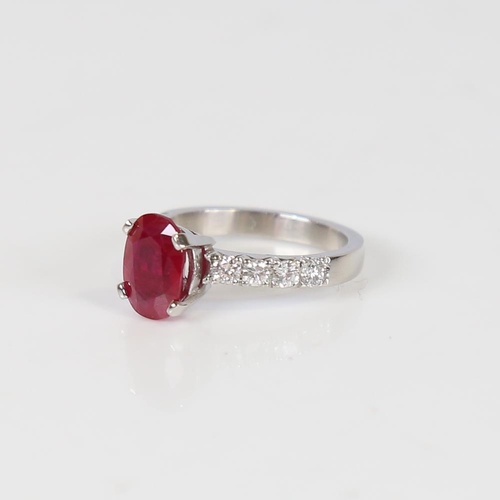 597 - A Burmese ruby and diamond dress ring, unmarked platinum settings with a 2.13ct oval mixed-cut ruby ... 