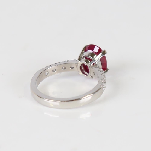 597 - A Burmese ruby and diamond dress ring, unmarked platinum settings with a 2.13ct oval mixed-cut ruby ... 