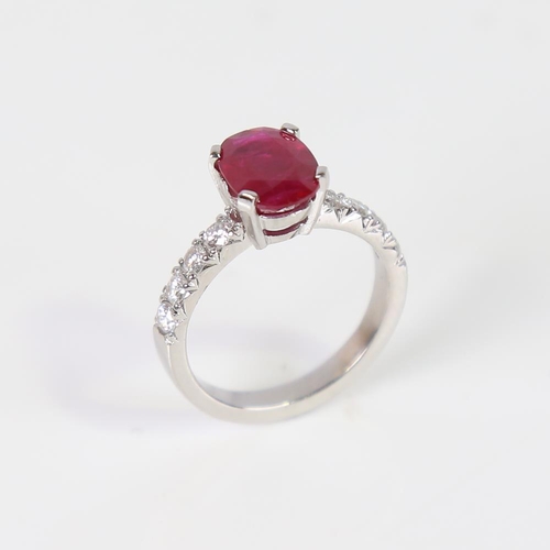 597 - A Burmese ruby and diamond dress ring, unmarked platinum settings with a 2.13ct oval mixed-cut ruby ... 