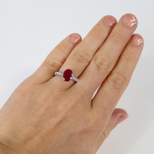 597 - A Burmese ruby and diamond dress ring, unmarked platinum settings with a 2.13ct oval mixed-cut ruby ... 