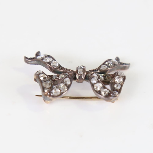 602 - A late 19th century diamond bow brooch, unmarked gold and silver settings with rose and old-cut diam... 